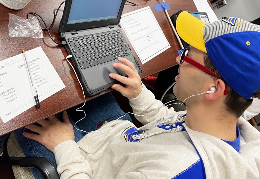 Chris refurbishes a computer to be used by students at Alton High School.