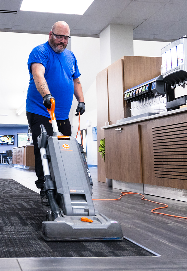 Custodial staff vacuuming