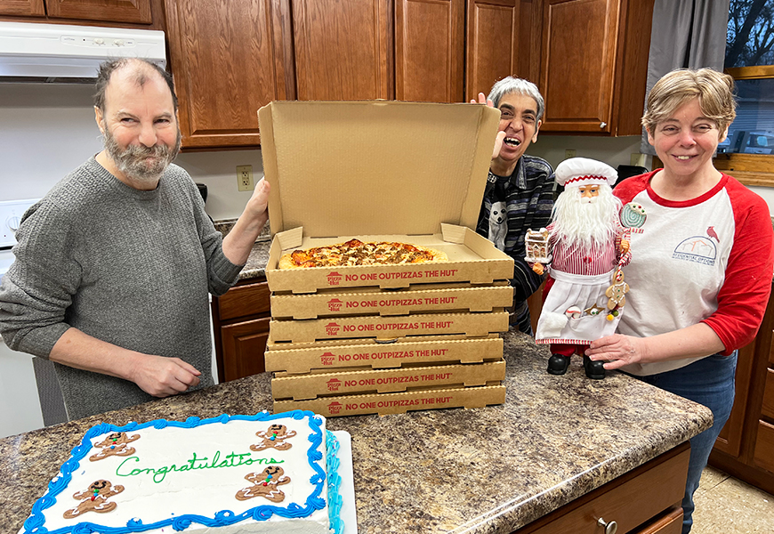 Residents enjoy pizza and cake after winning our gingerbread house contest.